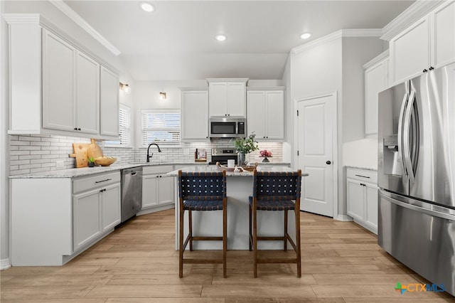 1827 Broken Shoe Trl, Temple, TX 76502 - kitchen featuring appliances with stainless steel finishes, a center island, recessed lighting, ornamental molding, and backsplash