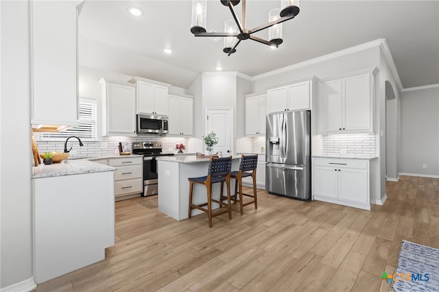 1827 Broken Shoe Trl, Temple, TX 76502 - kitchen featuring appliances with stainless steel finishes, crown molding, a center island, decorative backsplash, and white cabinets