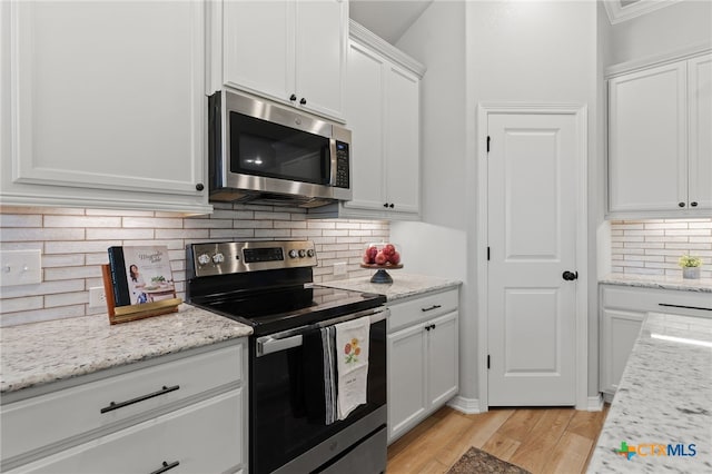 1827 Broken Shoe Trl, Temple, TX 76502 - kitchen with appliances with stainless steel finishes, white cabinets, tasteful backsplash, light wood-type flooring, and light stone countertops