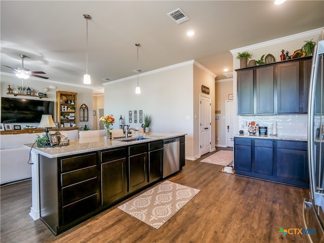 kitchen featuring light stone counters, decorative light fixtures, dark brown cabinets, and stainless steel appliances