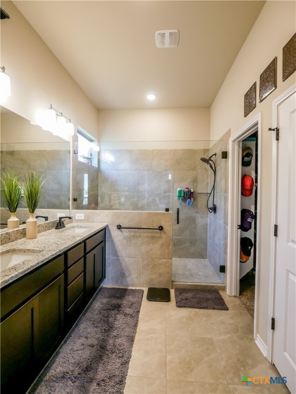 bathroom featuring walk in shower, vanity, and tile patterned floors