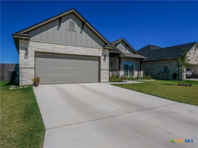 view of front of home with a garage and a front yard