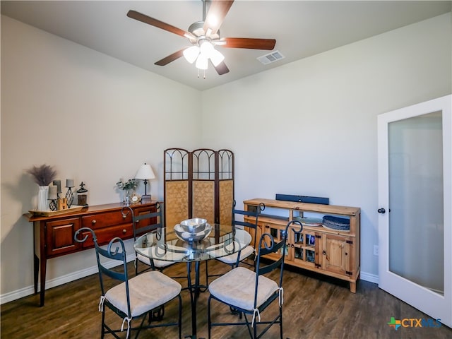 dining room with dark hardwood / wood-style flooring and ceiling fan