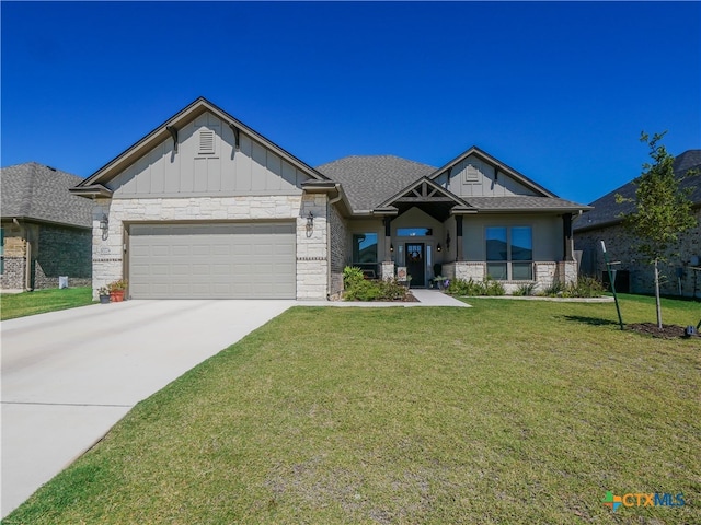 craftsman-style home featuring a garage and a front lawn