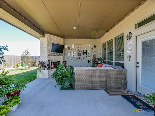 view of patio / terrace featuring an outdoor stone fireplace