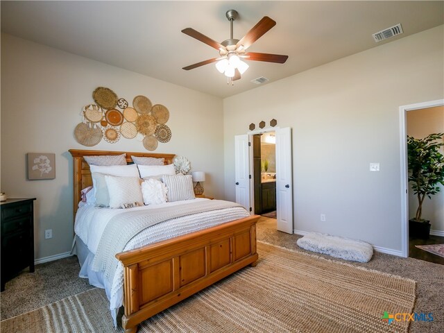 carpeted bedroom featuring connected bathroom and ceiling fan