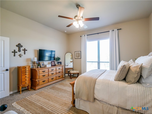 bedroom featuring light carpet and ceiling fan