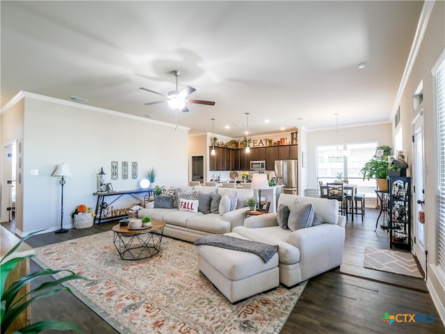 living room featuring dark wood-type flooring, ceiling fan, and ornamental molding