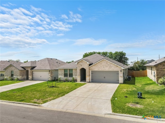 single story home featuring a garage and a front yard