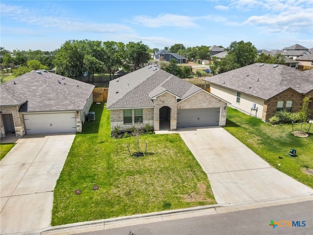 ranch-style house featuring a front lawn and a garage