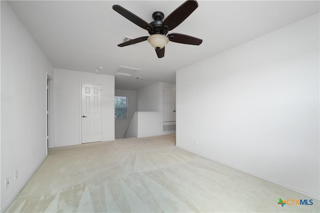 180 Beech Dr, Kyle, TX 78640 - empty room featuring a ceiling fan, light colored carpet, and attic access