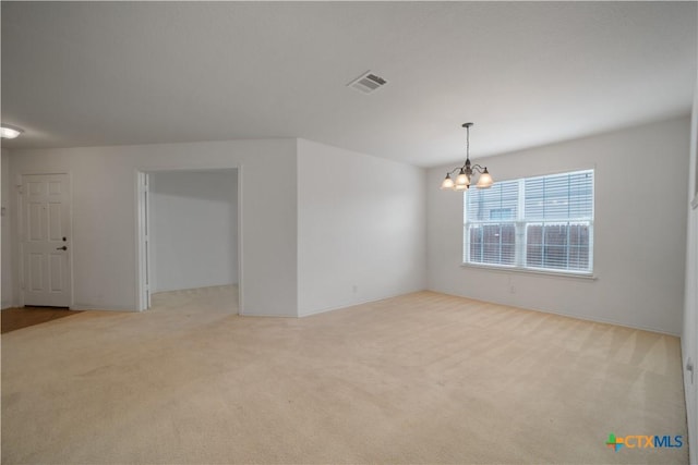 180 Beech Dr, Kyle, TX 78640 - empty room with a chandelier and carpet