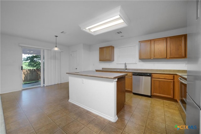 180 Beech Dr, Kyle, TX 78640 - kitchen with dishwasher, light tile patterned floors, a center island, light countertops, and brown cabinets