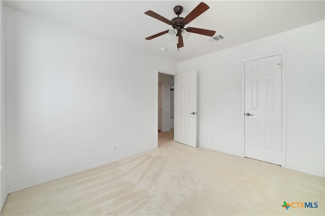 180 Beech Dr, Kyle, TX 78640 - unfurnished bedroom with light colored carpet and a ceiling fan