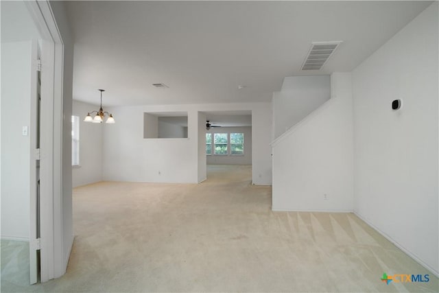 180 Beech Dr, Kyle, TX 78640 - spare room featuring light colored carpet, a chandelier, and ceiling fan