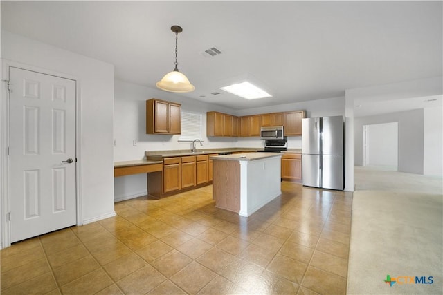 180 Beech Dr, Kyle, TX 78640 - kitchen with appliances with stainless steel finishes, light countertops, a center island, decorative light fixtures, and light tile patterned floors