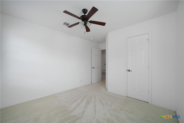 180 Beech Dr, Kyle, TX 78640 - unfurnished bedroom featuring light carpet and a ceiling fan