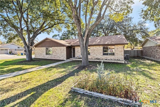 ranch-style house with cooling unit and a front lawn