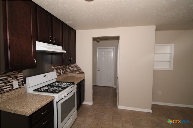 kitchen with backsplash, white gas range, dark brown cabinets, and a textured ceiling