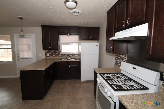 kitchen featuring decorative backsplash, pendant lighting, white appliances, and plenty of natural light