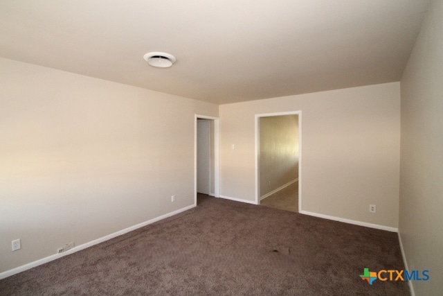 empty room with dark carpet