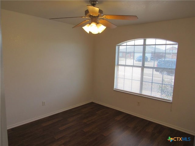 spare room with ceiling fan and dark hardwood / wood-style floors