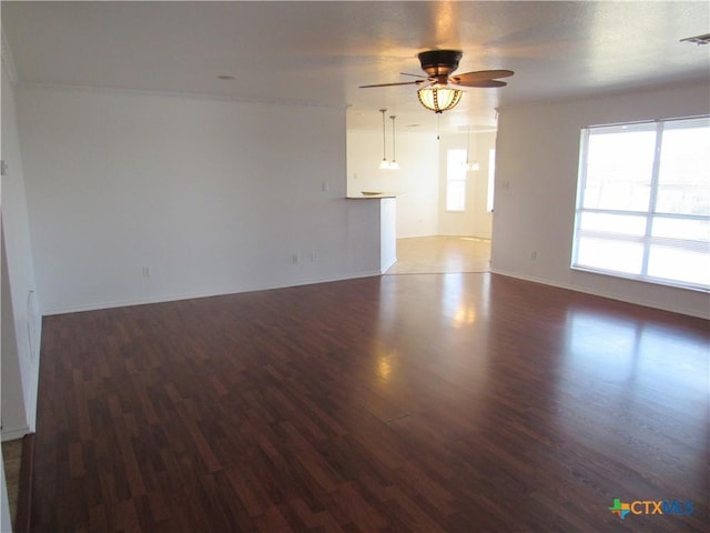 spare room featuring ceiling fan and dark wood-type flooring