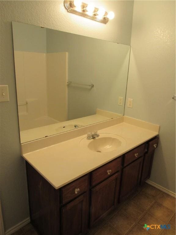 bathroom with tile patterned floors and vanity