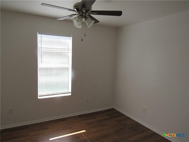 empty room featuring ceiling fan and dark hardwood / wood-style flooring