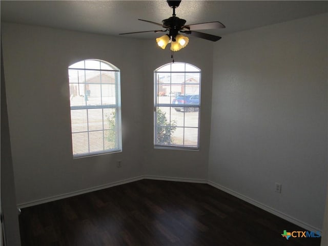 spare room featuring ceiling fan and dark hardwood / wood-style floors