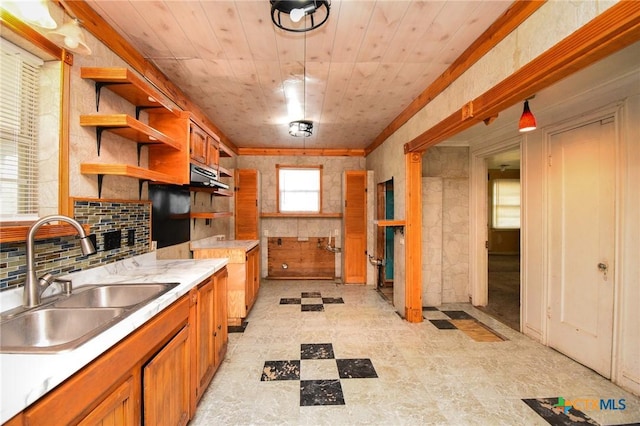 kitchen featuring pendant lighting, sink, tasteful backsplash, and wooden ceiling