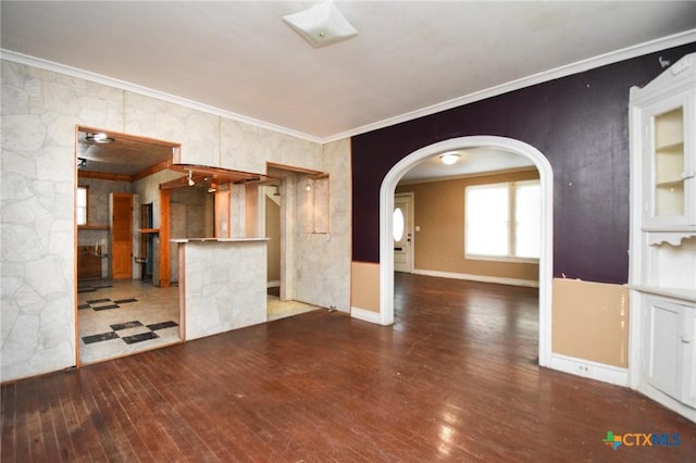 unfurnished living room featuring hardwood / wood-style flooring and crown molding