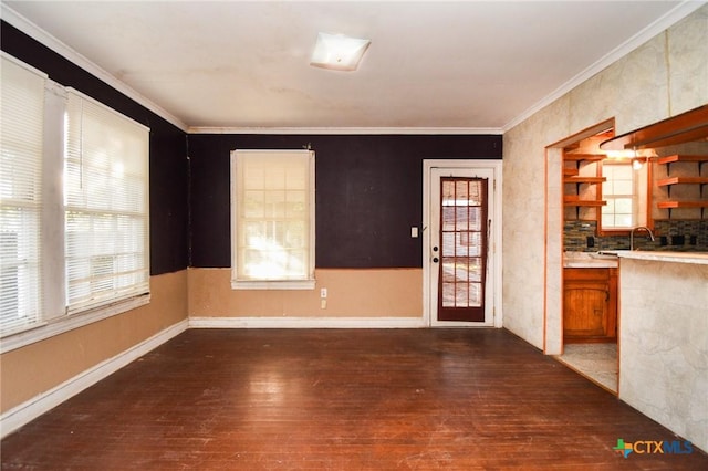 interior space featuring crown molding, dark hardwood / wood-style floors, and a healthy amount of sunlight