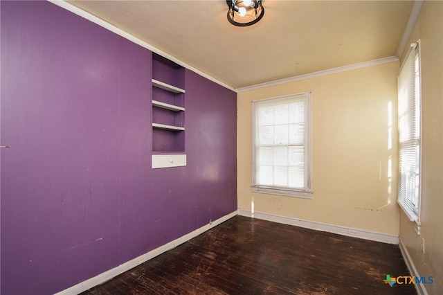 unfurnished room featuring wood-type flooring, ornamental molding, and built in features