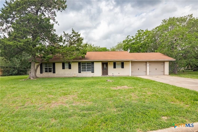 ranch-style home with a garage, concrete driveway, and a front yard