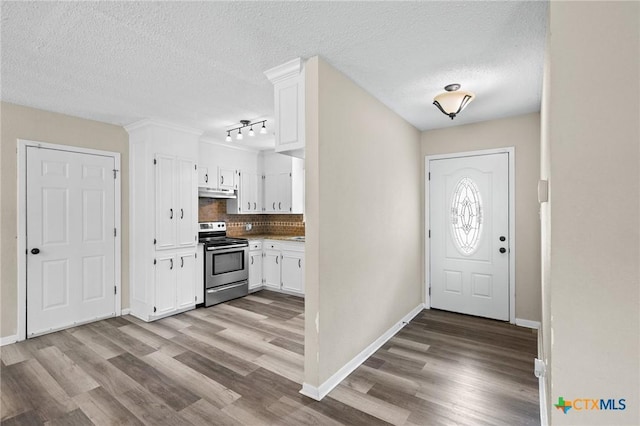 entryway featuring baseboards, a textured ceiling, rail lighting, and wood finished floors