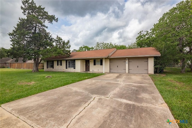 ranch-style home with a garage, fence, a front yard, and concrete driveway