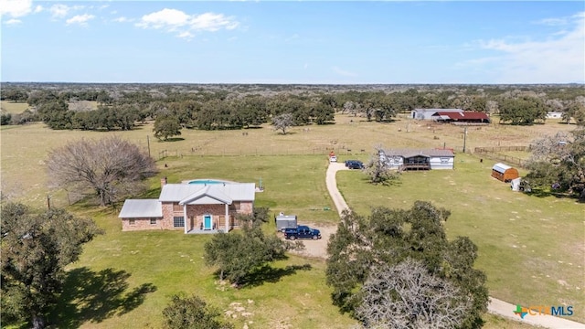 birds eye view of property with a rural view