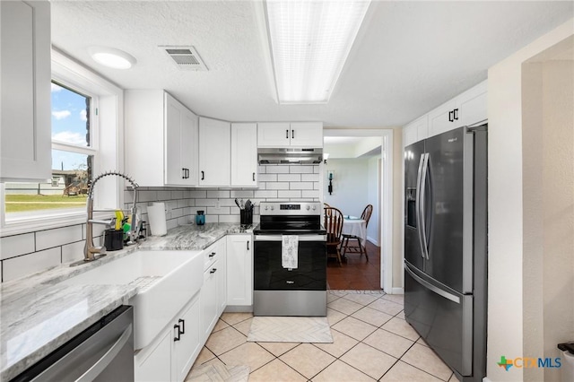 kitchen with visible vents, decorative backsplash, stainless steel appliances, under cabinet range hood, and white cabinetry