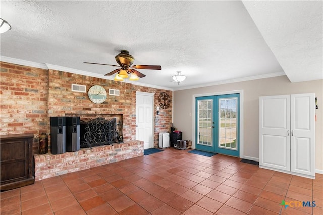 unfurnished living room featuring a fireplace, visible vents, crown molding, and french doors