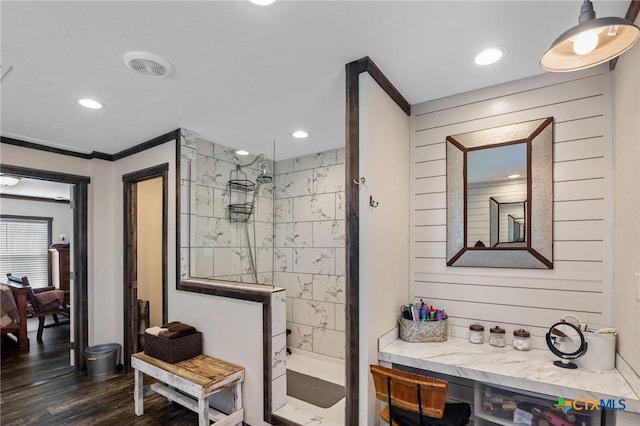 bathroom featuring recessed lighting, visible vents, ornamental molding, wood finished floors, and walk in shower