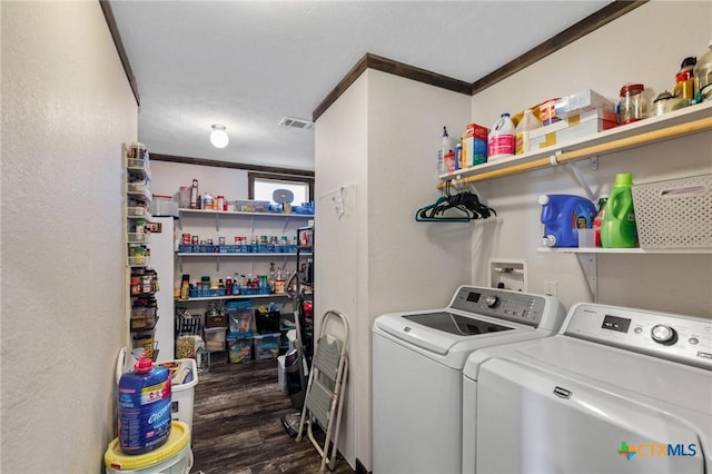 laundry room featuring laundry area, wood finished floors, washing machine and dryer, and visible vents