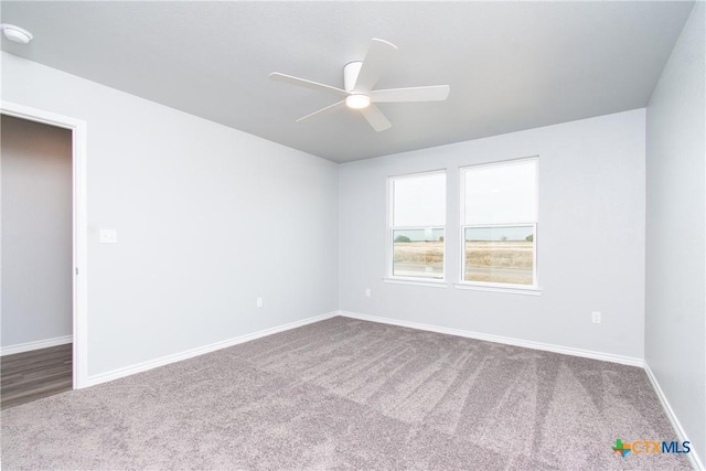 unfurnished room featuring carpet flooring, a ceiling fan, and baseboards