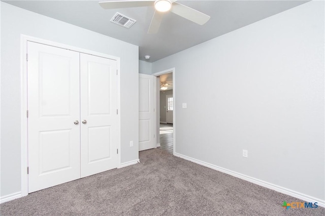 unfurnished bedroom featuring carpet flooring, a ceiling fan, visible vents, baseboards, and a closet