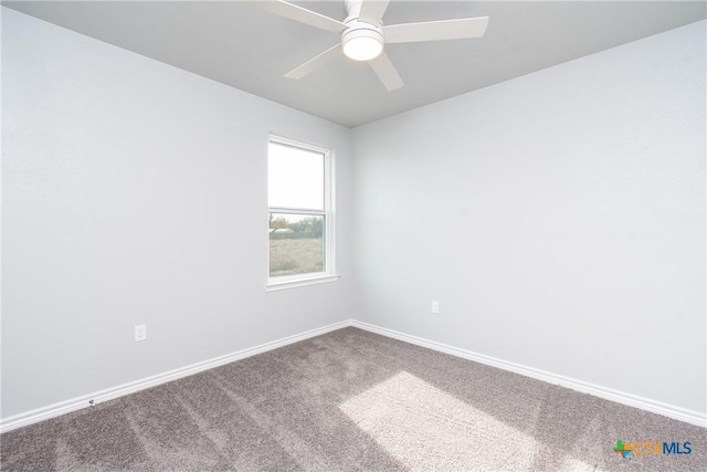 empty room with carpet floors, baseboards, and a ceiling fan