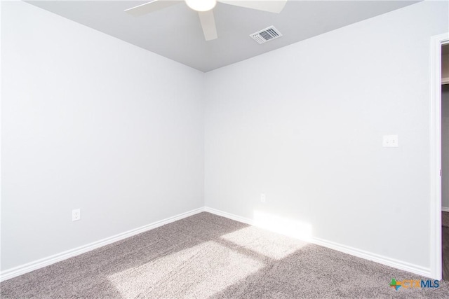 unfurnished room featuring ceiling fan, carpet flooring, visible vents, and baseboards