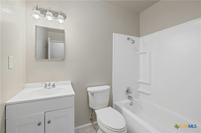 bathroom featuring  shower combination, vanity, and toilet