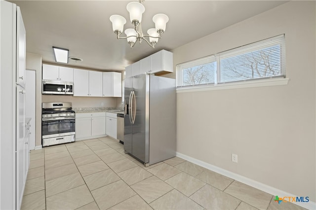 kitchen featuring light tile patterned floors, stainless steel appliances, light countertops, and white cabinets