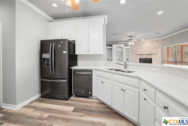 kitchen with light hardwood / wood-style floors, sink, appliances with stainless steel finishes, crown molding, and white cabinets