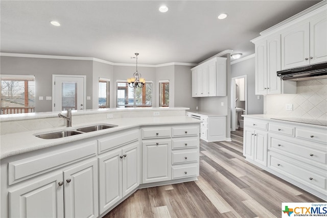 kitchen with a wealth of natural light, sink, and white cabinets